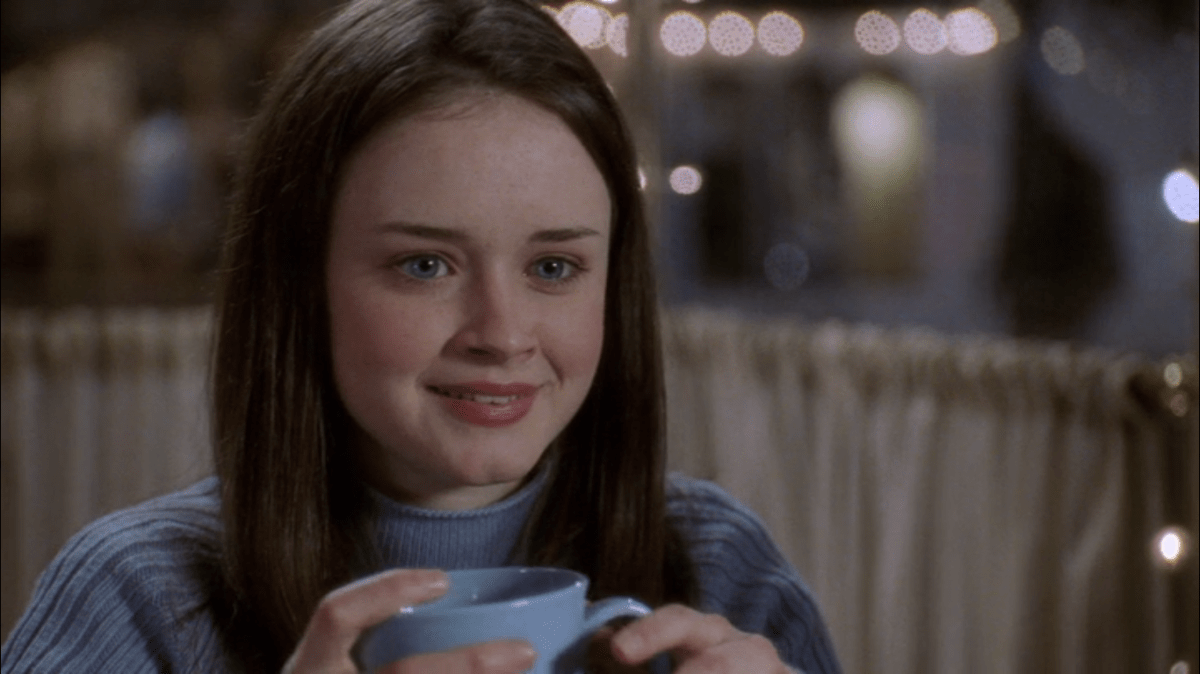 Rory holds a cup of coffee.