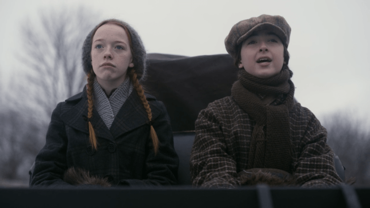 Anne and Jerry sit next to each other in the carriage, Anne rolling her eyes.