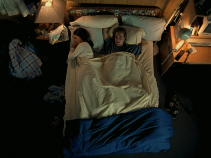 Overhead shot of Dawson and Joey sleeping side-by-side in bed.