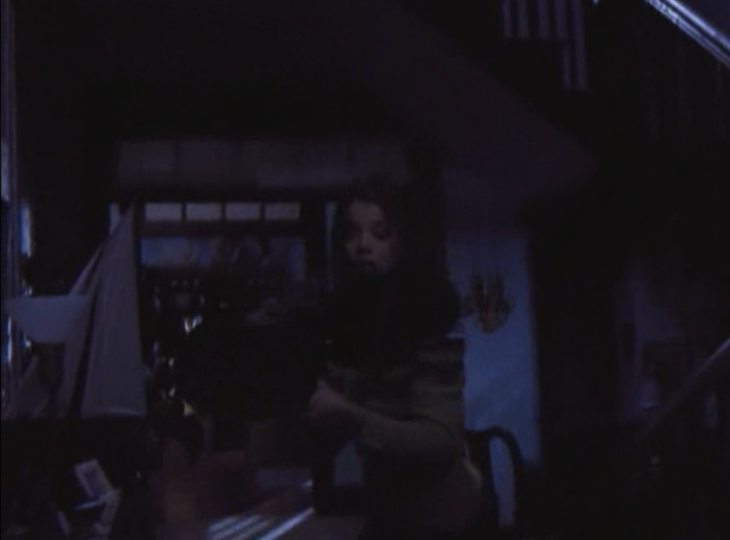 Dark blurry image with Joey holding a frying pan