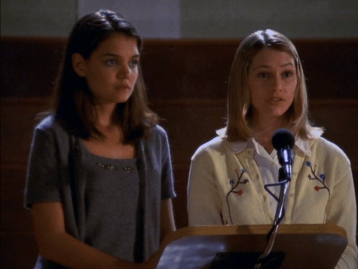 Andie and Joey stand at a podium.