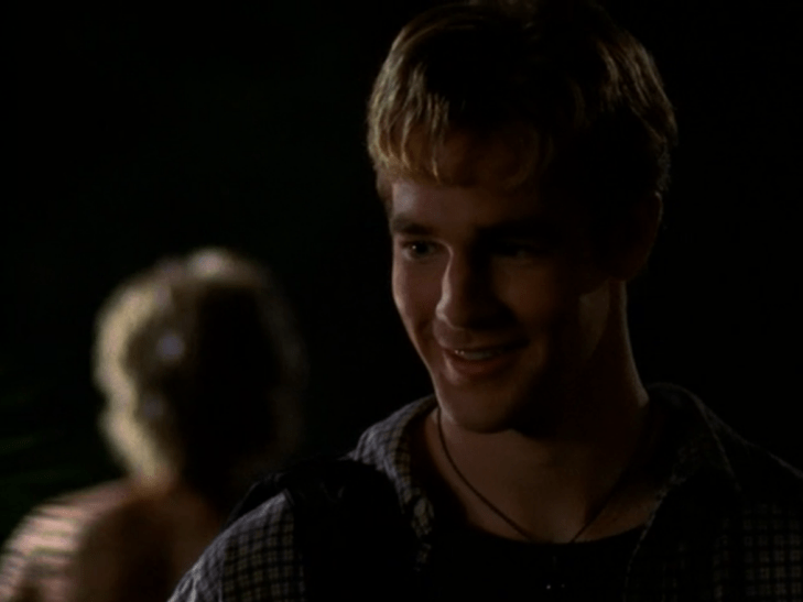 Dawson grins with a blurred naked Jen behind him.