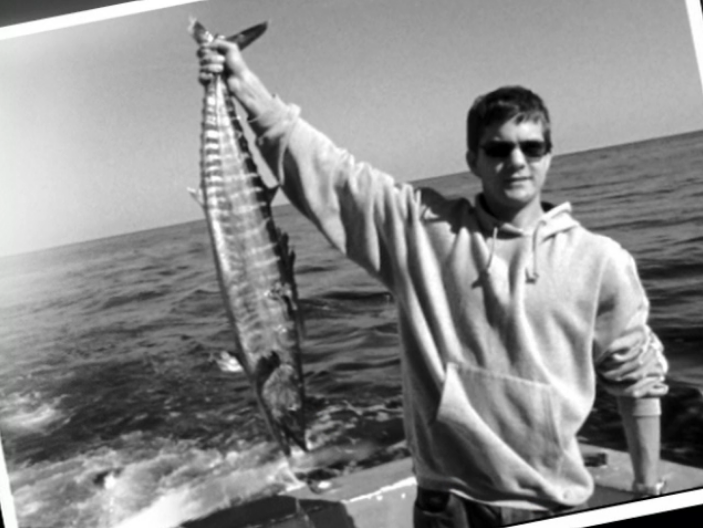 Image: Pacey triumphantly holding a big fish
