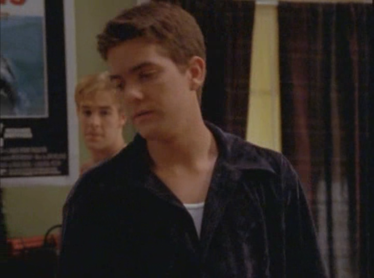 Pacey (standing in Dawson's room with Dawson) wears a navy blue velvet button-down shirt.