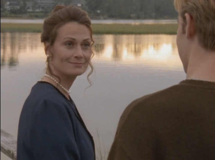 Preppy woman (Helen) gives languorous smile to Dawson (facing away from camera).