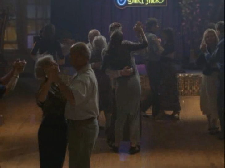 Joey stands on Pacey's feet while they dance.