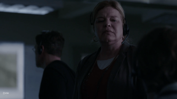 Sandy grimaces down at Clint, Max in the background.