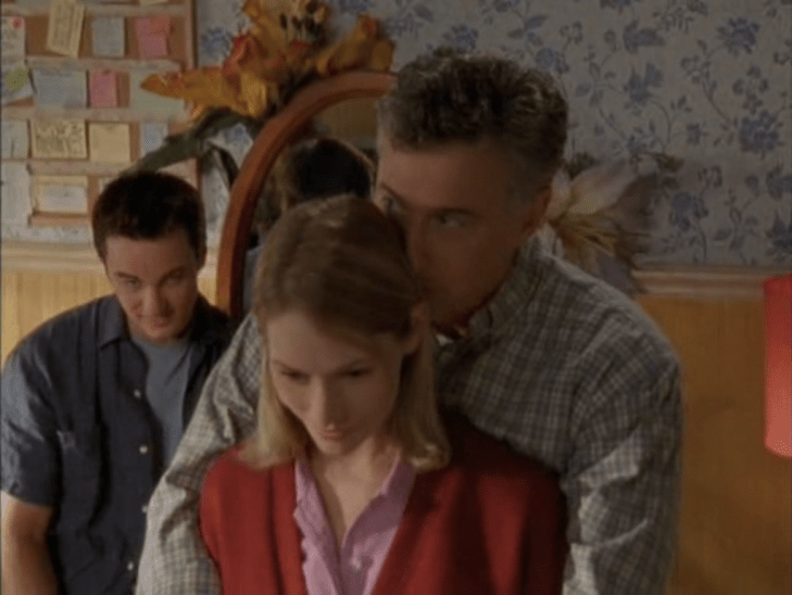 Interior, Andie's pastel-decorated room. Jack is in the background grinning weirdly while Mr. McPhee grabs Andie from behind and squeezes her in a pretty inappropriately tight hug.