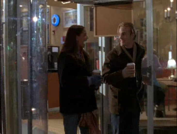 Exterior, night. Joey and Dawson emerge from a coffee shop holding cups of coffee and laughing.