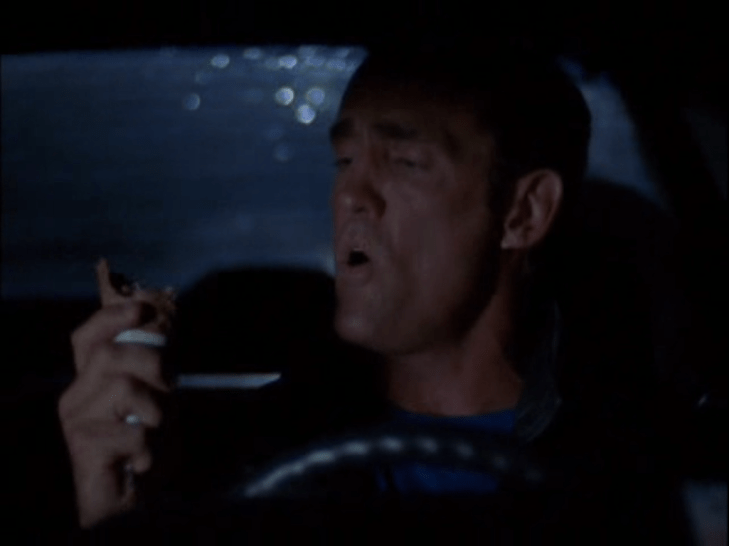 Mitch is seen behind the wheel, staring disappointedly at his broken ice cream cone.