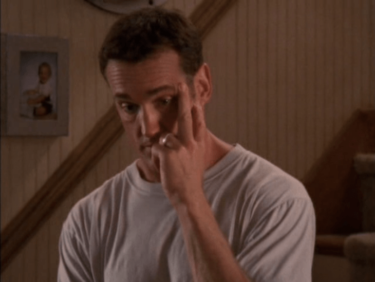 Middle-aged man (Mitch) holding his face with his hands and looking like he's about to give a massive eye-roll.