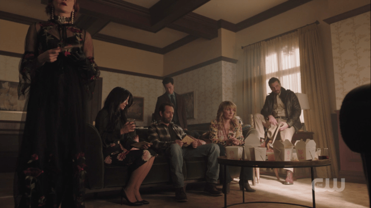 All the grownups are in a gathering, with takeout containers on a table, most of the characters in normal day clothes, and Penelope wearing a black sheer floor-length gown with roses, a choker, and giant earrings.