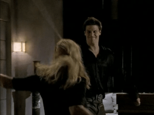 Angel and Buffy fighting. Angel's making a weird grimace.
