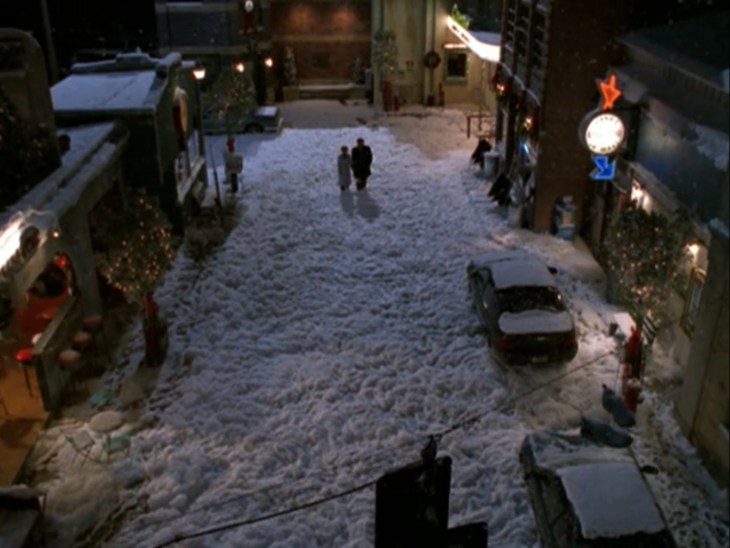Buffy and Angel walking through "snow" that looks like a foot of cotton candy.