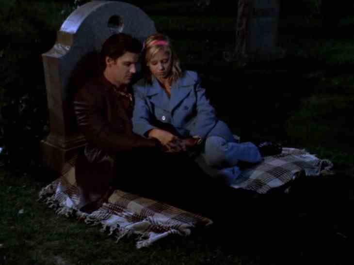 Image description: Buffy and Angel having a picnic at a cemetery.