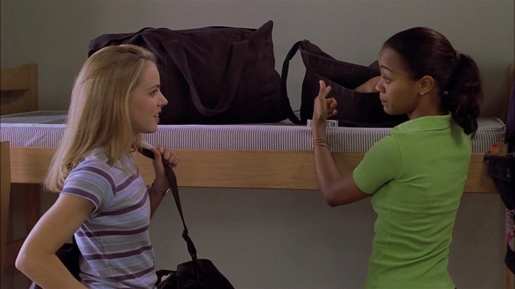 Image description: Jody and Eva stand in front of an unmade bunk bed.
